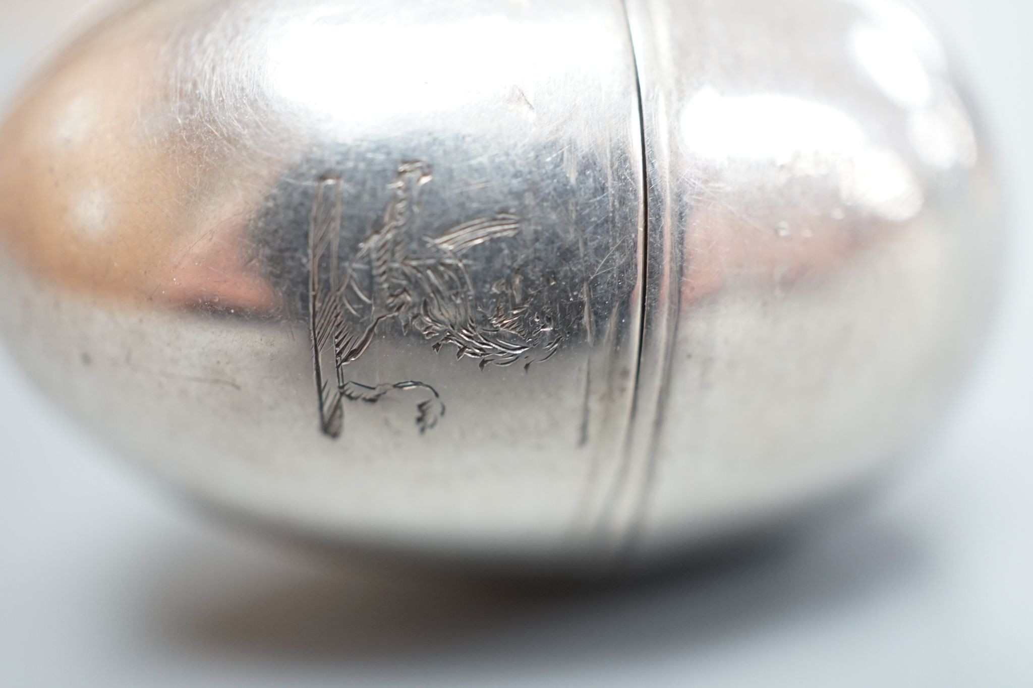 A George III silver egg shaped vinaigrette, by SM or WS, London, 1796, with engraved crest, 40mm.